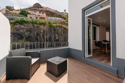 a room with a balcony with a table and chairs at Stylish 1 Bed Room in Funchal