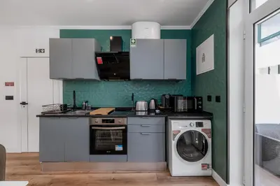 a kitchen with a washing machine and a washer at Stylish 1 Bed Room in Funchal
