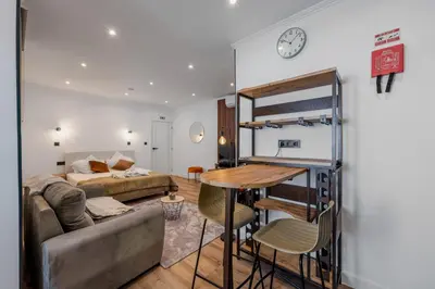 a living room with a couch and a table at Stylish 1 Bed Room Studio Flat in Funchal