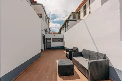 a room with couches and tables on a building at Stylish 1 Bed Room Studio Flat in Funchal
