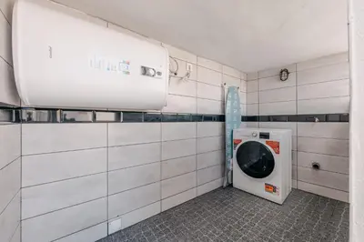 a laundry room with a washing machine in it at Stylish 1 Bed Room Studio Flat in Funchal