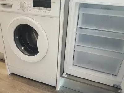 a washing machine with its door open next to a washer at Tranquil Escape in Gaula