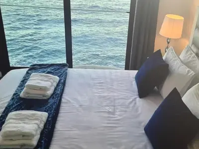 a bed in a room with a view of the ocean at Tranquil Escape in Gaula
