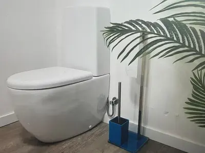 a white toilet in a bathroom with a plant at Tranquil Escape in Gaula