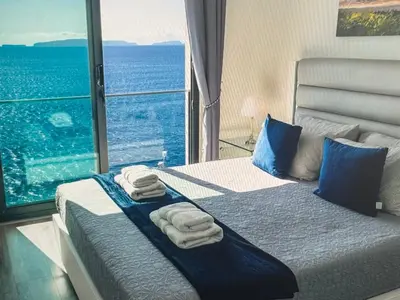 a bedroom with a bed with towels and a large window at Tranquil Escape in Gaula