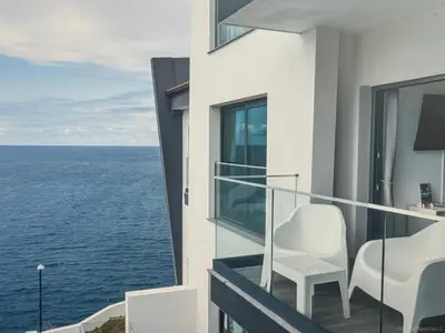 a balcony with chairs and a view of the ocean at Tranquil Escape in Gaula