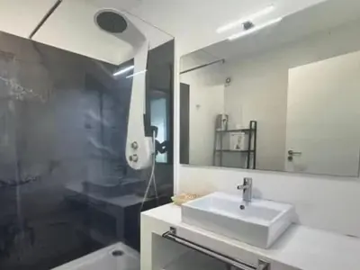 a bathroom with a sink and a shower and a mirror at Tranquil Escape in Gaula