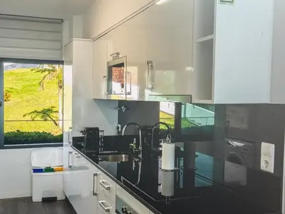 a kitchen with a sink and a glass counter top at Tranquil Escape in Gaula