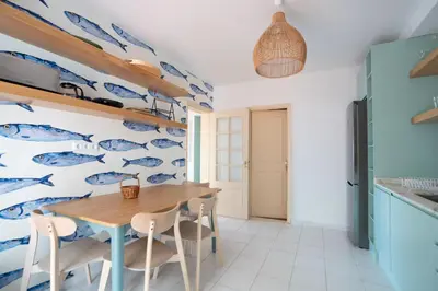 a dining room with a fish mural on the wall at Villa Jasmin by Atlantic Holiday in Caniço