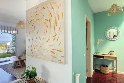 a living room with a painting on the wall at Villa Jasmin by Atlantic Holiday in Caniço