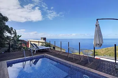 a swimming pool with a view of the ocean at Villa Jasmin by Atlantic Holiday in Caniço