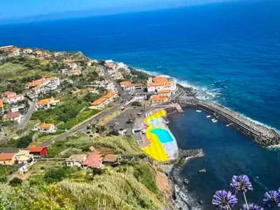 a boat in the water next to a beach at Charming island in Ponta Delgada