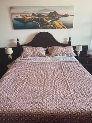 a bedroom with a large bed with a large painting on the wall at Charming island in Ponta Delgada