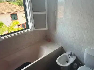 a bathroom with a tub and a sink and a window at Charming island in Ponta Delgada