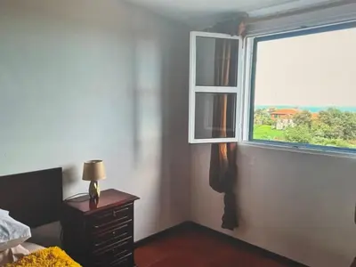 a bedroom with a window and a table with a lamp at Charming island in Ponta Delgada