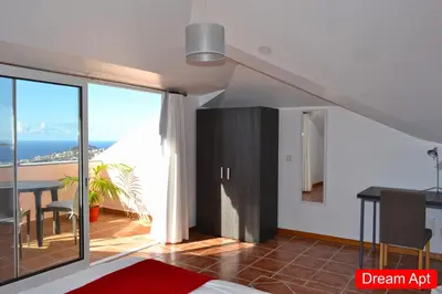 a living room with a dining table and a view of the ocean at Villa Henriques in Funchal