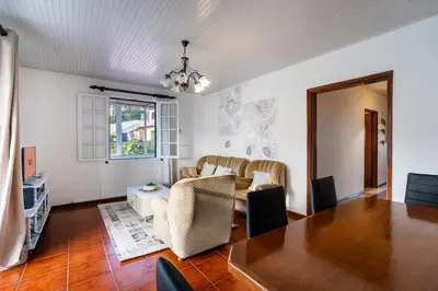 a living room with a table and a couch at GuestReady - Faia House in Gaula