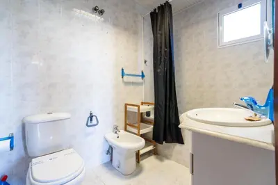 a bathroom with a toilet and a sink at GuestReady - Faia House in Gaula