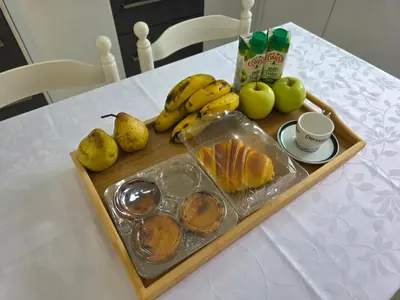 a tray of fruit on a table with pears and bananas at Villa Margarida São Vicente Madeira in São Vicente