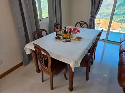 a dining room table with food and flowers on it at Villa Margarida São Vicente Madeira in São Vicente