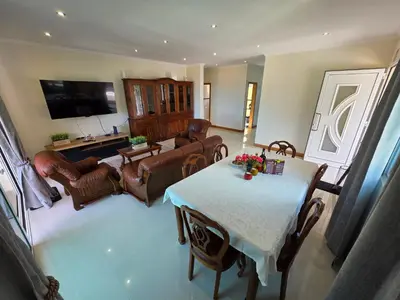 a living room with a table and chairs and a television at Villa Margarida São Vicente Madeira in São Vicente