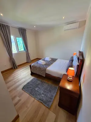 a bedroom with a bed and a wooden floor at Villa Margarida São Vicente Madeira in São Vicente