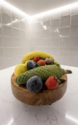 a wooden bowl of fruit on a table at Cathedral Houses in Funchal