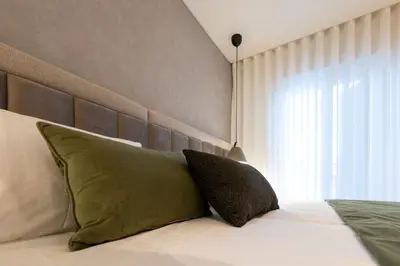 a bedroom with a bed with a large window at Cathedral Houses in Funchal