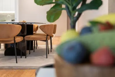 a table and chairs in a room with a plant at Cathedral Houses in Funchal