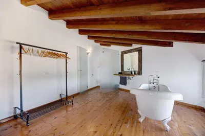 a bathroom with a tub and a toilet and a sink at House Fun Ride Surf School in Sagres