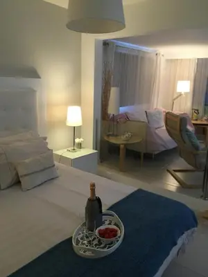 a bedroom with a bottle of wine and a bowl of fruit at Crystal Madeira Studio in Funchal
