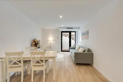 a dining room and living room with a table and chairs at Mercy by the Sea by Holiday Rental Madeira in Machico