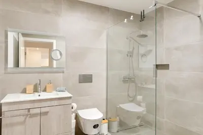 a bathroom with a shower and a toilet and a sink at Mercy by the Sea by Holiday Rental Madeira in Machico