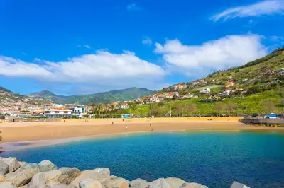 a view of a beach with people on the sand at Mercy by the Sea by Holiday Rental Madeira in Machico