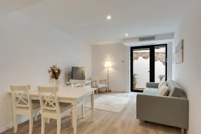 a dining room and living room with a table and chairs at Mercy by the Sea by Holiday Rental Madeira in Machico
