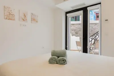 a white room with a table with towels on it at Mercy by the Sea by Holiday Rental Madeira in Machico
