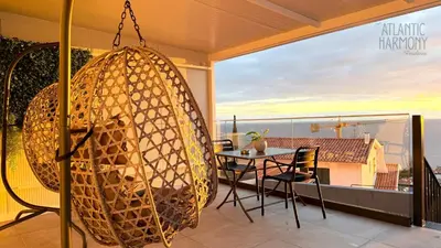 a room with a swing and a table on a balcony at Atlantic Harmony Residences in Funchal