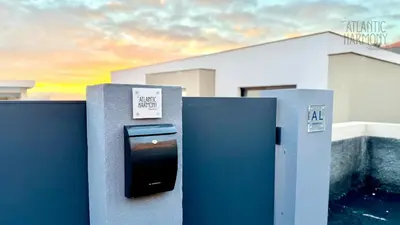a pay meter with a sign on it in front of a house at Atlantic Harmony Residences in Funchal