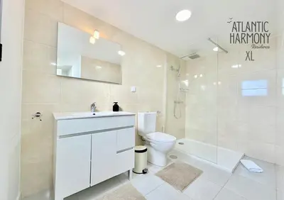 a white bathroom with a sink and a toilet at Atlantic Harmony Residences in Funchal
