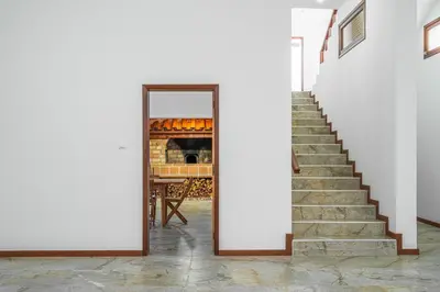 a stairway with a mirror in a room at Casa do Vale in São Vicente
