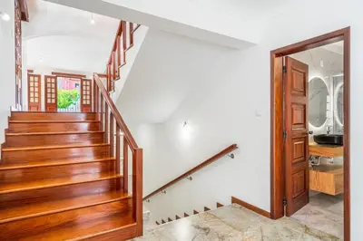a staircase in a house with a wooden stair case at Casa do Vale in São Vicente