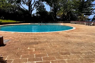 a small swimming pool with a brick patio at Tutti studio by Turin in Funchal