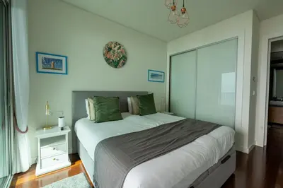 a bedroom with a large bed and a window at Bogi's APT by LovelyStay in Funchal
