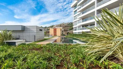 an exterior view of a building with a swimming pool at Bogi's APT by LovelyStay in Funchal