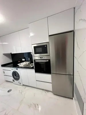 a white kitchen with a refrigerator and a microwave at Heart of Madeira Funchal in Funchal