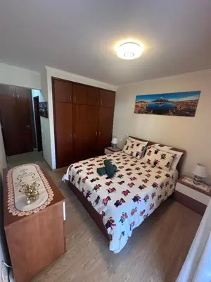 a bedroom with a large bed with a wooden headboard at Heart of Madeira Funchal in Funchal