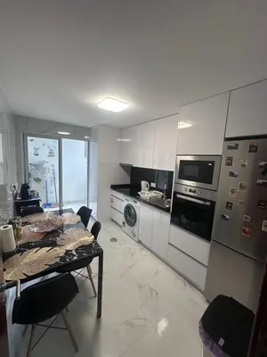 a kitchen with a table and a stove top oven at Heart of Madeira Funchal in Funchal