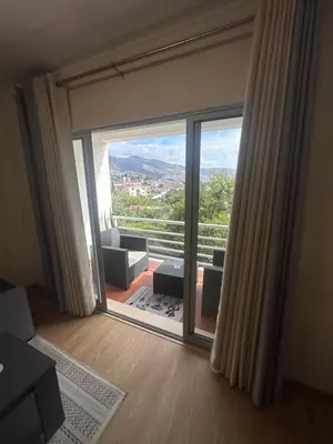 a room with a large sliding glass door with a view at Heart of Madeira Funchal in Funchal