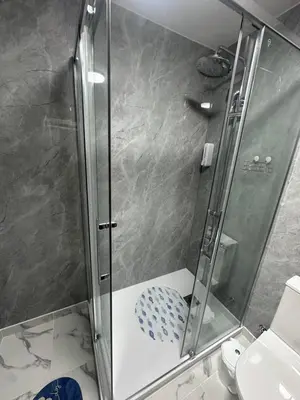 a shower with a glass door in a bathroom at Heart of Madeira Funchal in Funchal