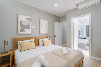 a bedroom with two beds and a bathroom at Linda Vista Apartment by Amazing Madeira in Funchal